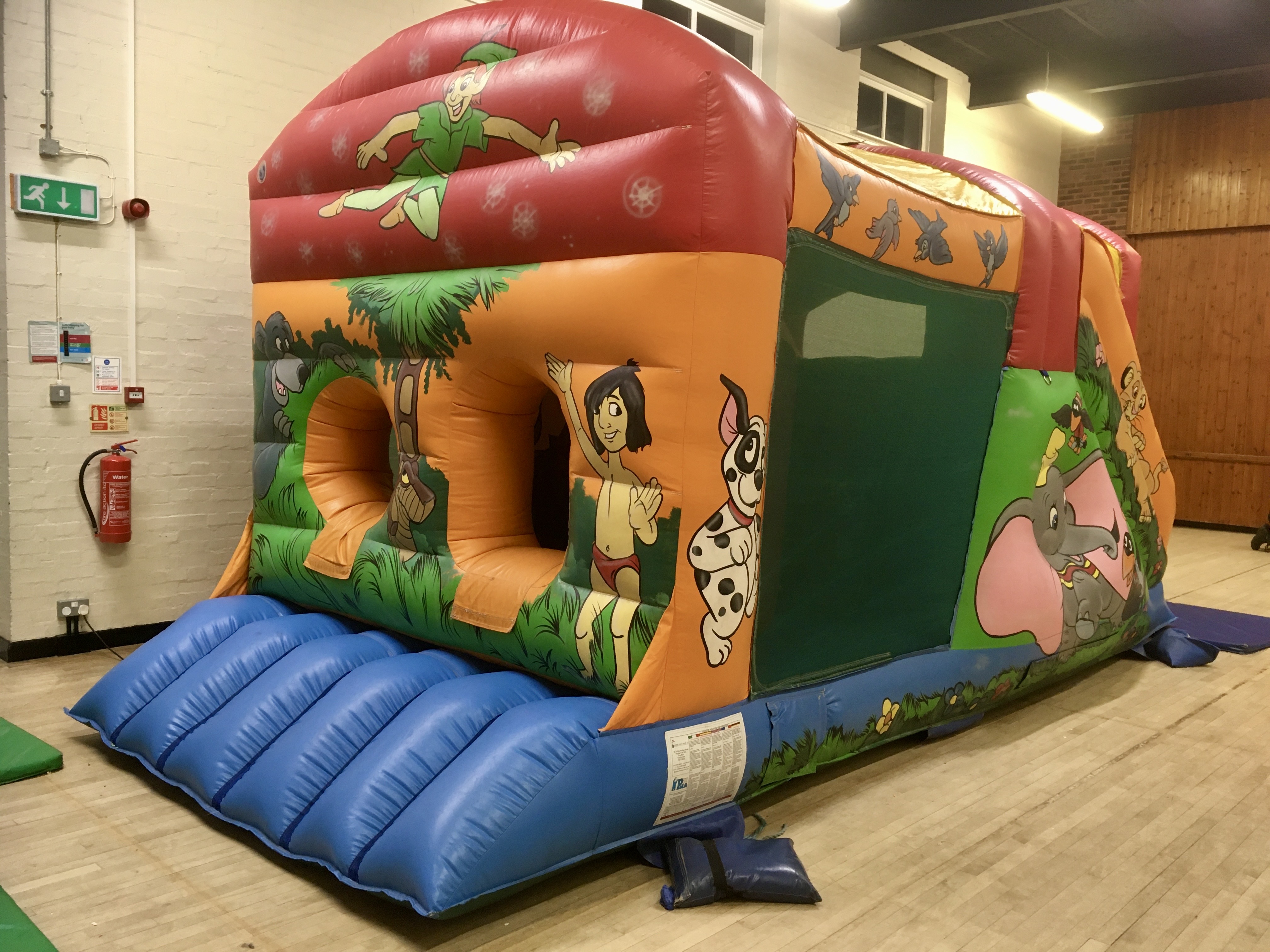 Cartoon Fun Run bouncy castle hire in Swanley Cartoon Fun Run bouncy castle set up inside a hall in Swanley