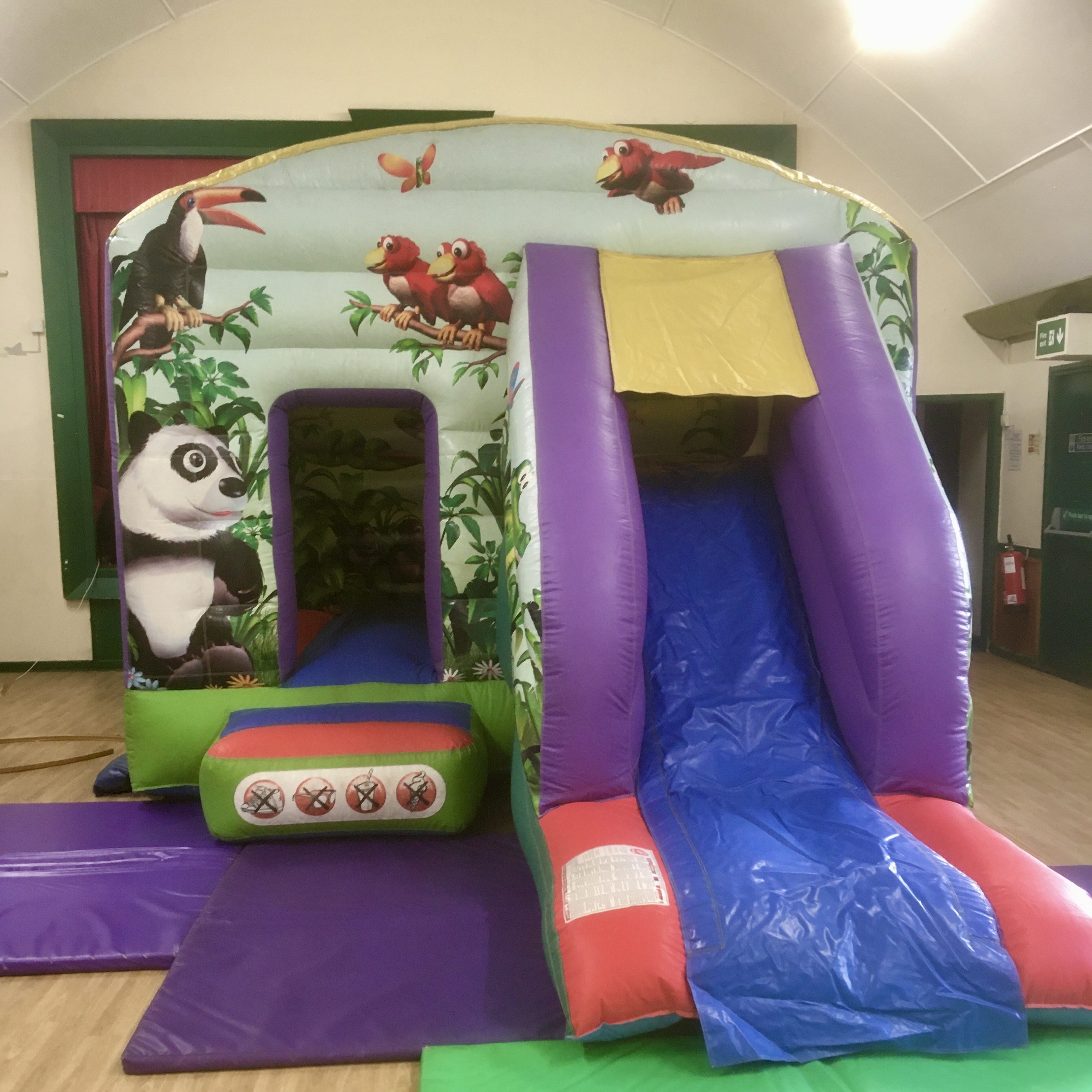 Jungle Bounce & Slide Castle hire in Belvedere Jungle Bounce & Slide Castle set up inside a church hall in Belvedere